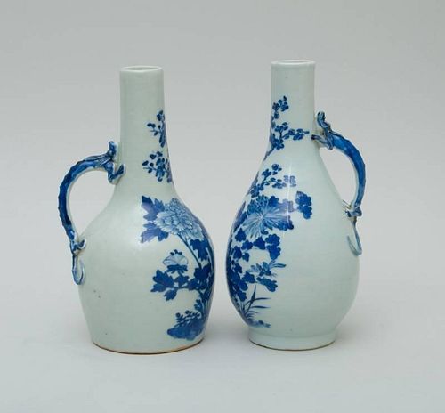 TWO SIMILAR CHINESE BLUE AND WHITE PORCELAIN CARAFFES WITH DRAGON HANDLES
