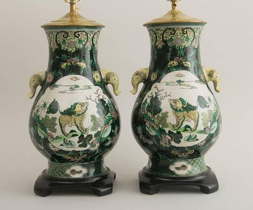 PAIR OF CHINESE BLACK GROUND FAMILLE VERTE PORCELAIN PEAR-FORM VASES, MOUNTED AS LAMPS