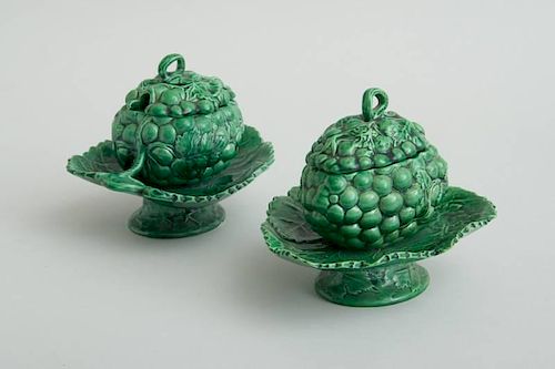 PAIR OF ENGLISH GREEN-GLAZED POTTERY GRAPE CLUSTER TUREENS, ON ATTACHED STANDS AND COVERS