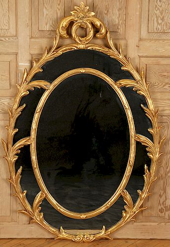 LARGE OVAL GILT MIRROR WITH FOLIATE DECORATION