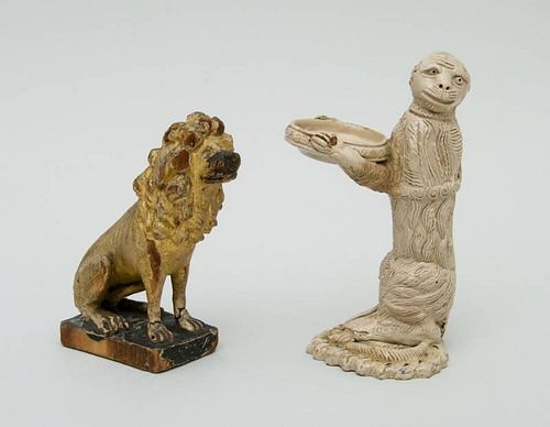 CONTINENTAL POTTERY MONKEY-FORM TRINKET TRAY AND A CARVED GILTWOOD SEATED LION