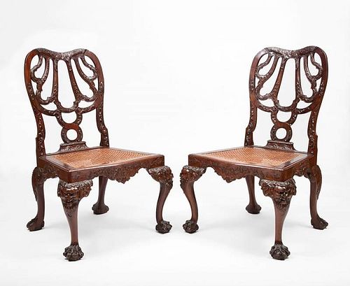 PAIR OF GEORGE III STYLE CARVED MAHOGANY AND CANED SIDE CHAIRS