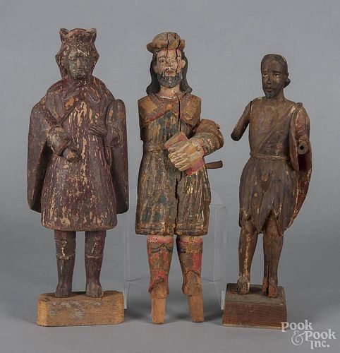 Three carved and painted Santos figures, 19th c., 17'' h., 17 1/2'' h., and 18 1/4'' h.