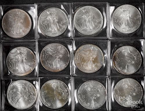 Eighteen American Eagle 1 ozt. fine silver coins.