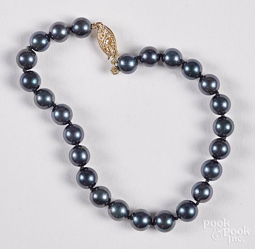 Black pearl bracelet with a 14K yellow gold clasp