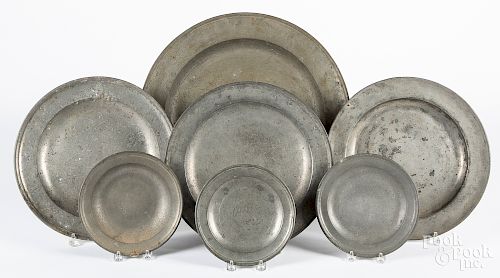 Seven English pewter plates and chargers, etc.
