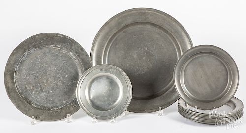 Eleven pewter plates and a charger, etc.