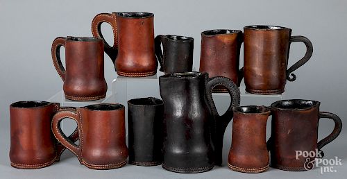 Eleven contemporary leather mugs