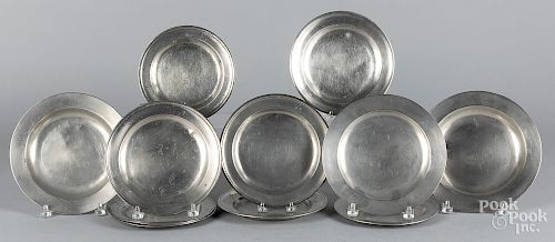Eleven English pewter plates and shallow bowls
