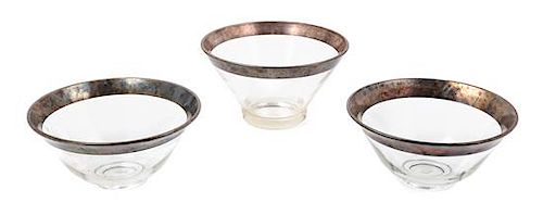 A Set of Three Silver-Rimmed Glass Nesting Bowls Height of largest 6 inches.