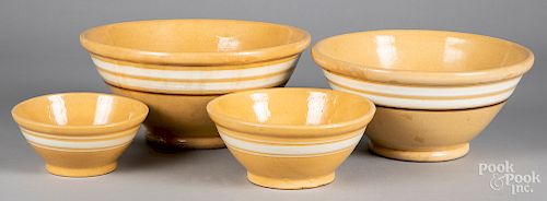 Four yelloware mixing bowls