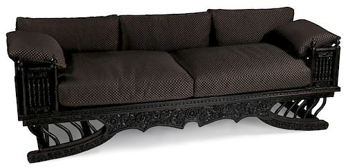 A LARGE CARVED WOOD HOWDAH STYLE THAI SOFA