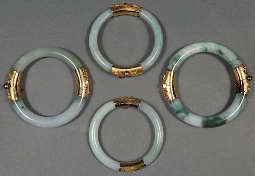FOUR CHINESE CARVED JADE BANGLES
