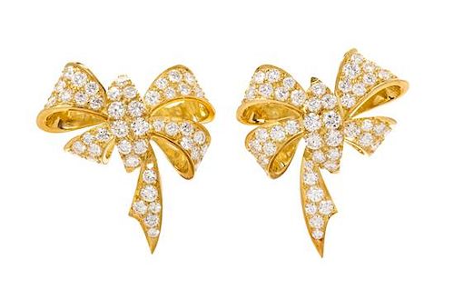 * A Pair of Yellow Gold and Diamond Bow Motif Earclips, 11.00 dwts.