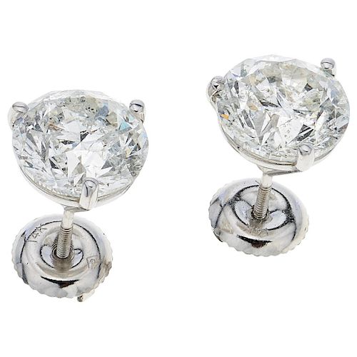 A pair of diamond 14K white gold stud earrings.