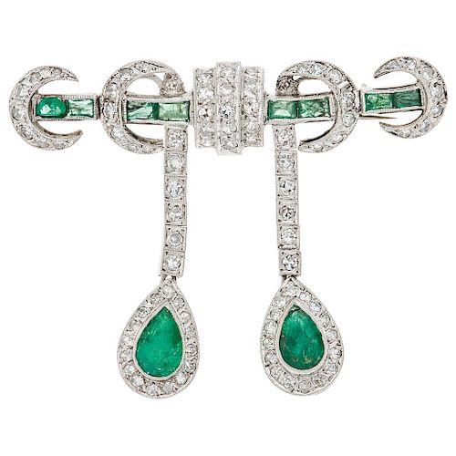 An emerald and diamond palladium silver brooch.