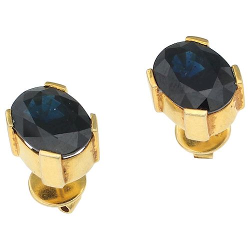 A pair of sapphire 14K yellow gold stud earrings.