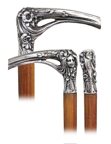 48. Silver Figural Art Nouveau Cane -Ca. 1900  -L-shaped silver handle, well-modeled, heavy cast and finely hand chased to depict a female head in Sym