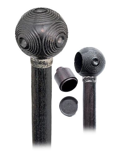 59. Ebony Puzzle Container Cane -Ca. 1880 -Ebony ball knob turned with five identical, concentric circles panels, plain silver collar and an ebony sha