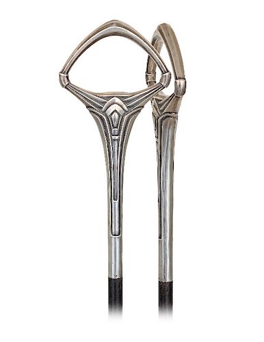 85. Feminine Art Deco Dress Cane -Ca. 1920 -Vertical silver handle with a stretching stem expanding in a triangular loop characterized with bursting, 
