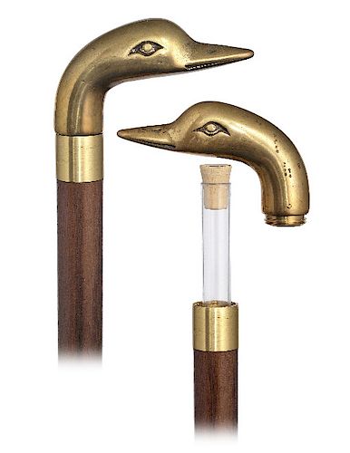 137. Tippler Cane -20th Century -Classic flask cane with a cast and  threaded brass duck head, which opens to release a 5” short flask concealed  in the sold at auction on 8th
