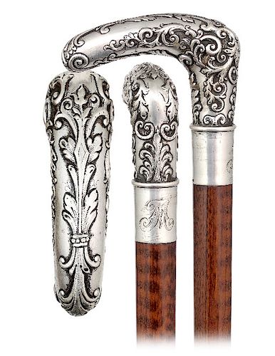 174. Silver Day Cane -Ca. 1890 -L-shaped silver handle modeled with pleasing rounded edges and hand chased in a rich Baroque taste with dense scrolls,