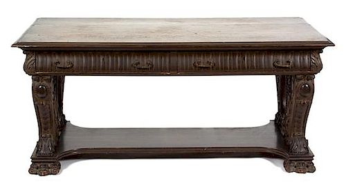 A Continental Renaissance Revival Carved and Stained Oak Library Table Height 29 3/4 x width 66 1/4 x depth 36 inches.