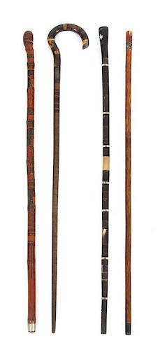 A Group of Four Miscellaneous Canes Length of largest 35 1/2 inches.