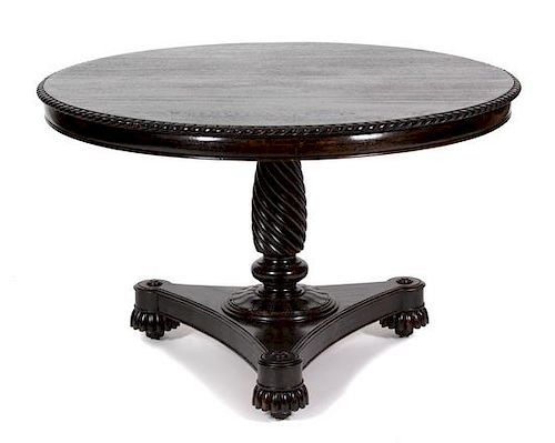 A Regency Style Carved Mahogany Center Table Height 30 1/2 x diameter 47 inches.