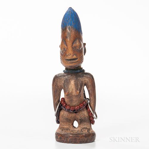 Female Yoruba Ibeji Figure, standing on a circular base, with raised feet, legs set apart with the arms detached from the body and hand