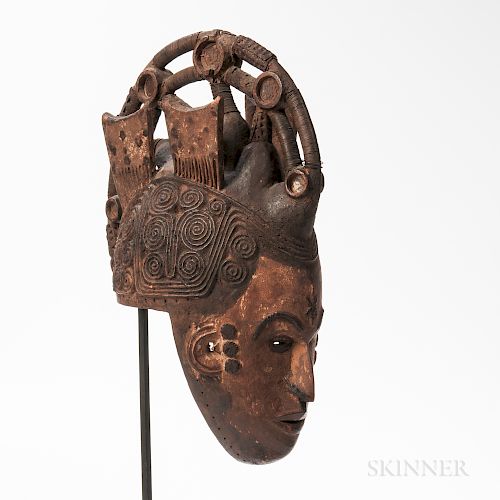 Ibo Maiden Spirit Helmet Mask, Agbogho Mmuo, the hollowed-out helmet form pierced around the rim for attachment of a cloth head coverin