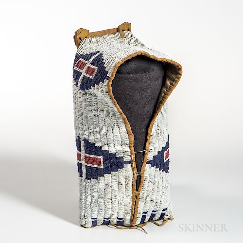 Cheyenne Beaded Cloth and Hide Model Cradle Cover, fourth quarter 19th century, mounted on a wood slat framework showing traces of yell