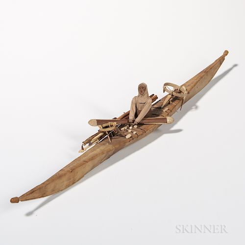 Inuit Kayak Model, early 20th century, animal skin with bone decorated accoutrements and wood figure wearing a cloth parka, lg. 26 1/2