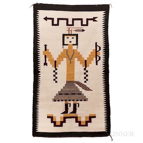 Navajo Yei Rug, c. 1930s, homespun wool, with solitary Yei dancer holding a bow and arrow, surrounded by black border, 63 1/2 x 36 1/4