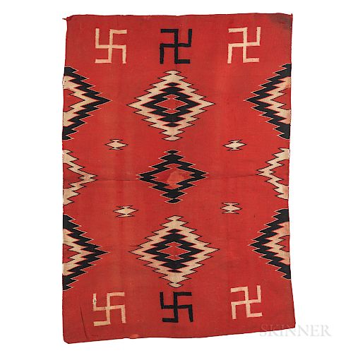 Navajo Blanket, c. 1900, the tightly woven blanket with a polychrome diamond "eye dazzler" pattern, with whirling logs on a red ground,