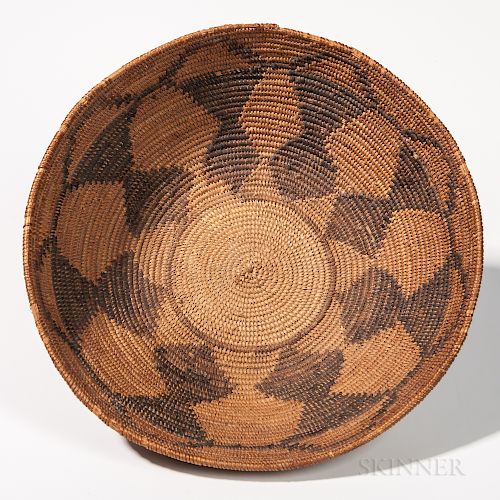 Large Washoe Polychrome Basketry Bowl, Nevada, c. 1875-85, flat-bottom form with repeated geometric designs decorating the sloping side