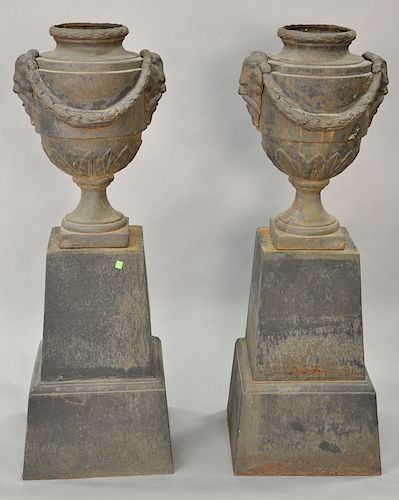 Pair of large iron outdoor urns on bases, total height 56 inches.