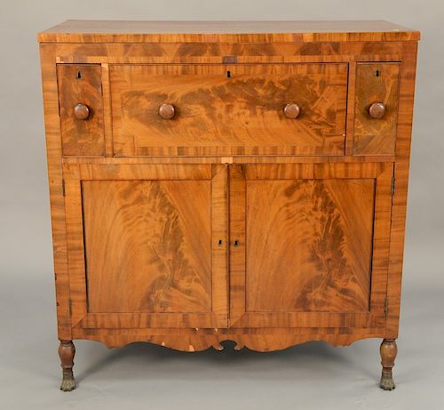 Federal mahogany sideboard having three drawers over two doors, all set on turned legs ending in brass paw feet, circa 1830. height ...