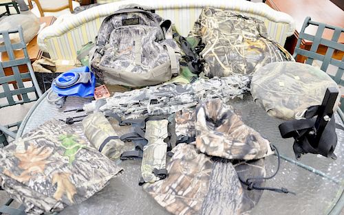 Group of hunting gear and clothes to include large overalls, targets, button down shirt, tree post, gloves, hunting blind, two bags,...