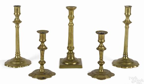 Two pairs of Queen Anne brass candlesticks, 18th c., together with a single candlestick