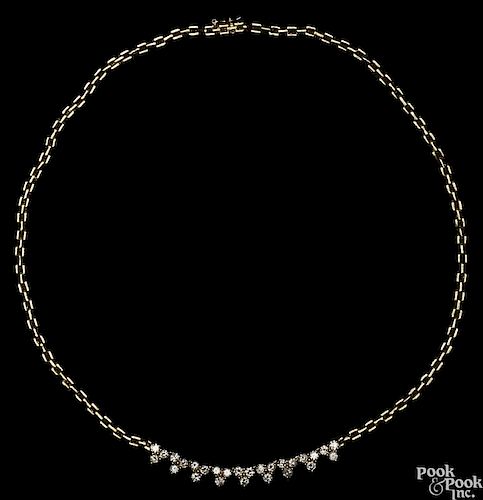 18K yellow gold and diamond necklace, centering around brilliant cut diamonds in clusters of three