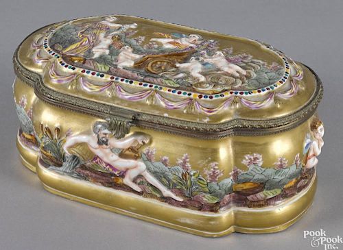 Capodimonte porcelain dresser box, late 19th c., with relief figural decoration, 4'' h., 9 1/4'' w.