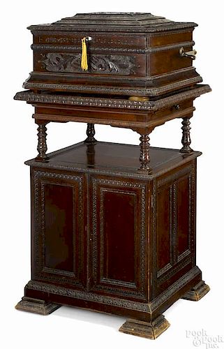 Criterion mahogany disc music box and stand, late 19th c., elaborately carved