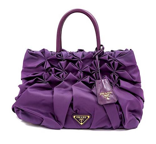 A Prada Purple Tessuto Nylon Origami Handbag with Leather Gloves and Earmuffs, Handbag: 7.5" H x 14" W x 8.25" D; Handle drop: 4