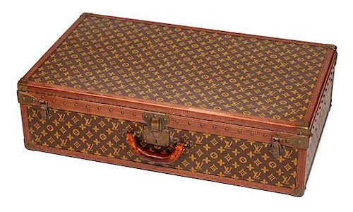 A Louis Vuitton Stenciled Monogram Hardsided Suitcase, 19" H x 31.5" W x 8" D; Handle drop: 2".