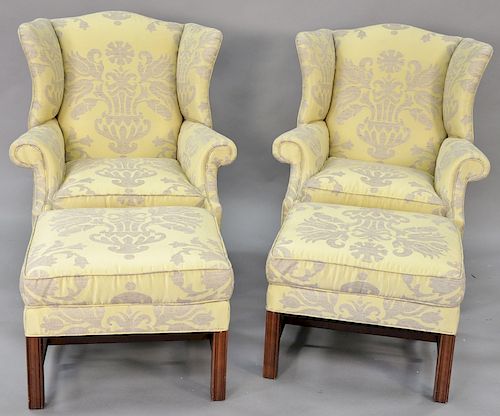 Pair Chippendale style wing chairs with matching ottomans in a yellow and brown upholstery, height to top of back of chairs 42 inche...