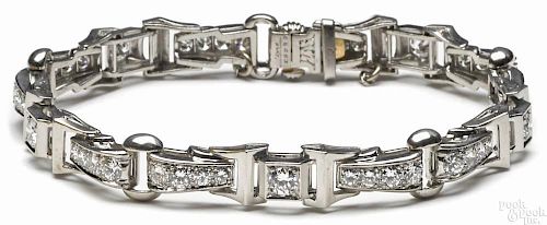 Platinum and diamond tennis bracelet containing forty-six round, brilliant cut diamonds