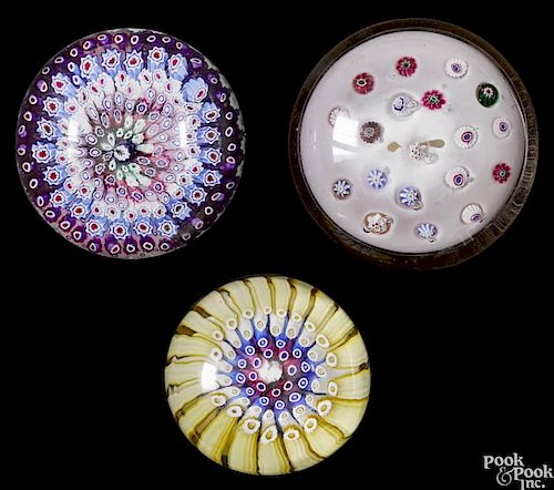 Three antique glass paperweights, to include a concentric millefiori with a central rabbit cane