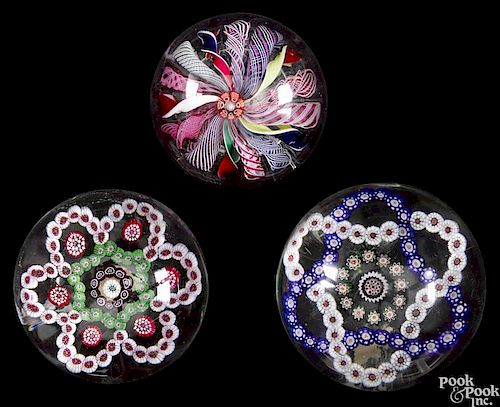 Three antique glass paperweights, to include two examples with interlacing millefiori bands