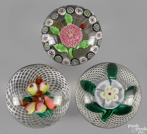 Three antique glass paperweights, to include two fruit and floral examples with latticino grounds